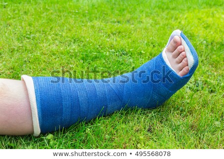 Stock fotó: One Gypsum Leg Of Boy On Grass