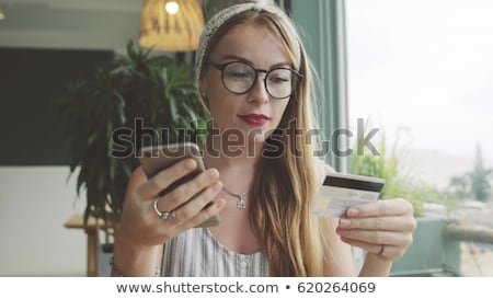 Foto d'archivio: Woman Using Digital Tablet To Make A Payment With Credit Card