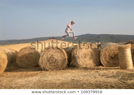 Foto stock: Young Boy On Hay Bales