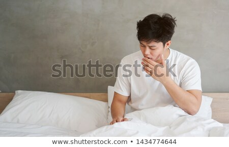 Foto d'archivio: Sleepy Man Yawning On Bed