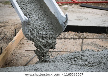 Stock photo: Construction Worker Smoothing Wet Cement With Trowel Tool