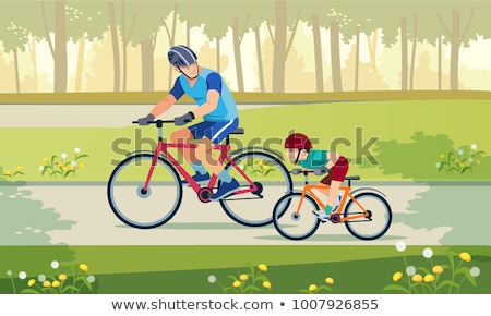 Stockfoto: Happy Family Is Riding Bikes Outdoors And Smiling Father On A Bike And Son On A Balancebike