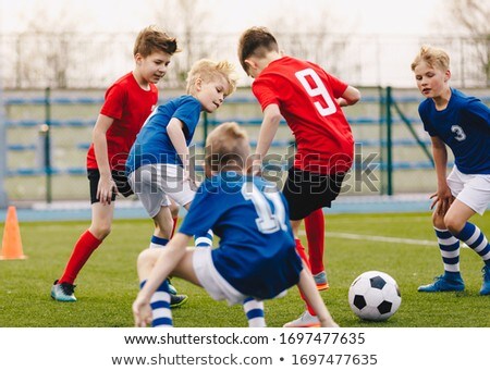 Boy As A Soccer Or Football Player With The Ball Stockfoto © matimix