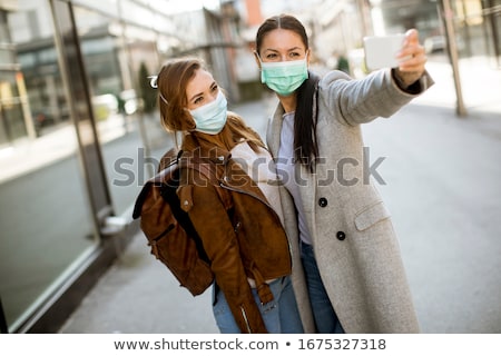 Stock photo: Pretty Young Woman With Protective Facial Mask On The Street