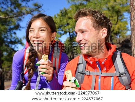 Stok fotoğraf: Hiker Man Healthy Outdoor Lifestyle Eating Muesli Bar During Hike On Mountain Hiking Happy People E