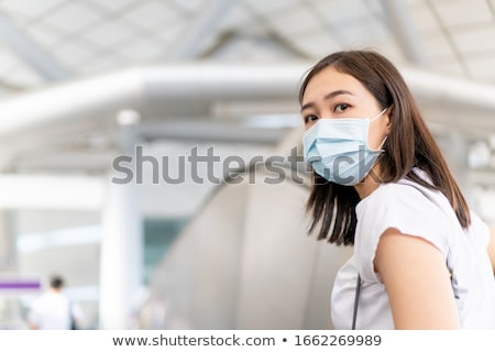 Stock fotó: Young Woman Wearing A Hygiene Protective Mask Over Her Face While Walking At The Crowded Place Heal