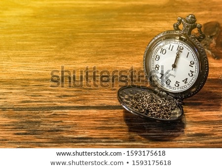 Foto stock: Pocket Watch Over Grunge Wooden Table