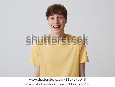 Stockfoto: Positive Boy Looking At Camera Isolated Over White