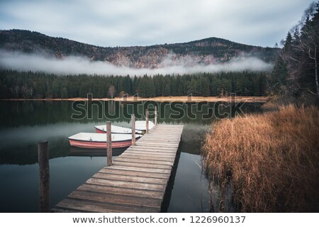 ストックフォト: Beautiful Moody Sunrise Over Calm Lake With Boat On Shore