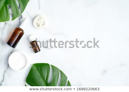 Сток-фото: Monstera Leaves And Cosmetic Care Products