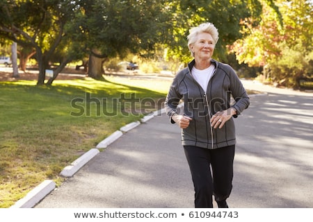 Zdjęcia stock: Senior Woman Jogging Through Park