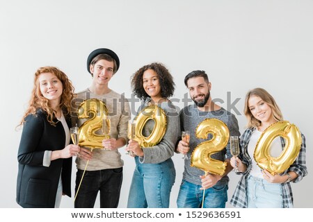 Zdjęcia stock: Young Joyful Friendly People Holding Number Of New Year And Flutes With Chamagne