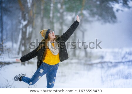 Stock photo: A Woman In The Winter Period Has Fun And Enjoys Life In The Snowy Outdoors