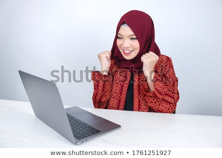 Stock foto: Young Asian Islam Woman Wearing Headscarf Is Shocked And Excited With What She See On Laptop On The