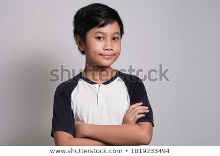 Stock photo: Serious Little Boy With Hands Folded Standing Isolated On White