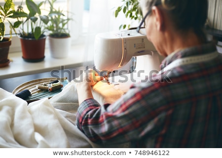 Stock photo: Back View Of Seamstress Working With Sewing Machine