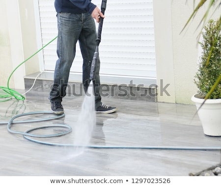 Foto d'archivio: Cleaning Terrace With A Pressure Washer