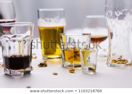 Stock fotó: Glasses Of Different Alcohol Drinks On Messy Table