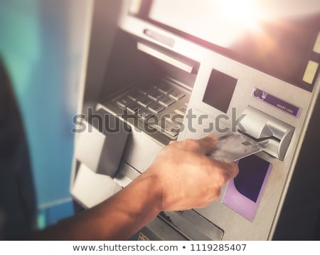Stockfoto: Close Up Of Woman Inserting Card To Atm Machine