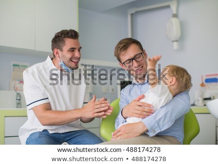 Stock fotó: Father And Son Visiting Dentist At Dental Clinic