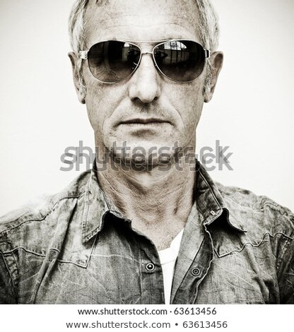 Stock fotó: Attractive Man Wearing Sunglasses Posing With A Serious Look