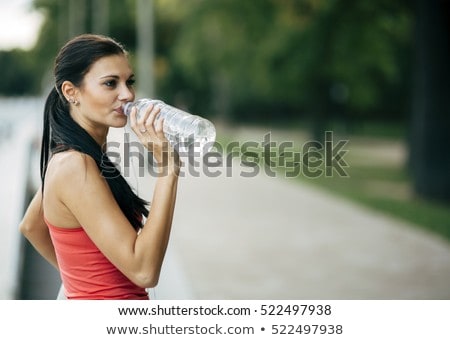 商業照片: Thirsty Woman Drinking Water To Recuperate