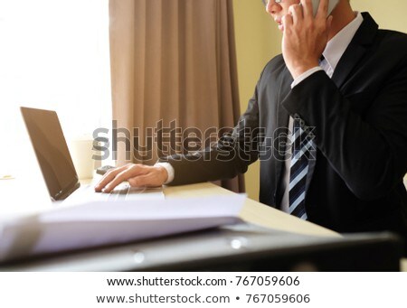 Stock fotó: Businessman Sitting At Table Touching A Glass Sheet