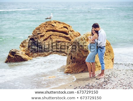 Stock fotó: A Pregnant Woman With Her Husband On The Beach Touching Her Belly With Love