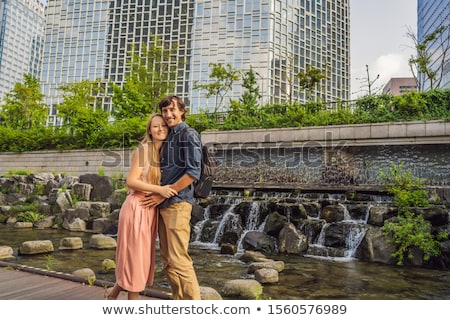 Foto stock: Young Woman Tourist In Cheonggyecheon Stream In Seoul Korea Cheonggyecheon Stream Is The Result Of