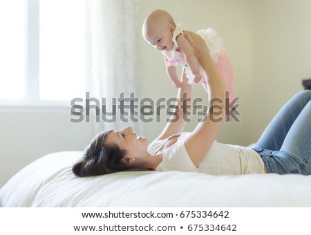 Stock photo: Portrait Of Mother With Her 3 Month Old Baby In Bedroom