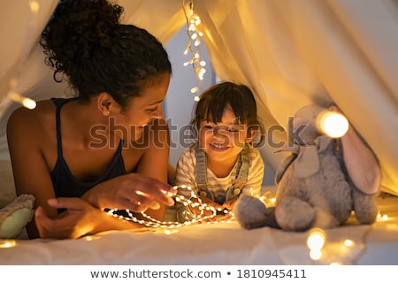 Foto stock: Smiling Multi Ethnic Girls Have Fun Together And Enjoy Home Party Inside The Camper Van