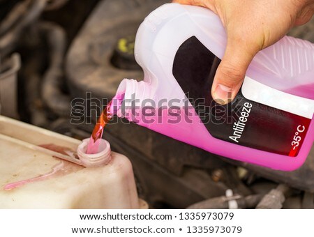 Stock photo: Hand Holding A Bottle Of Antifreeze