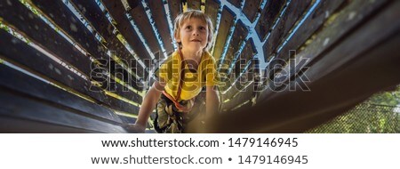 [[stock_photo]]: Little Boy In A Rope Park Active Physical Recreation Of The Child In The Fresh Air In The Park Tra