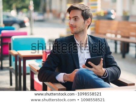 Foto stock: Portrait Of Handsome Young Male Employer Holds Digital Tablet Connected To Wireless Internet Wears