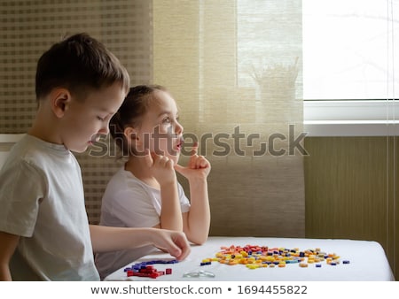 Stockfoto: Two Brothers Play Puzzle On The Table In The Childrens Room In The Scandinavian Style