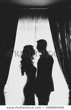 Stock photo: Portrait Of A Romantic Couple Silhouette Couple Of Lovers Groom And Bride At The Window