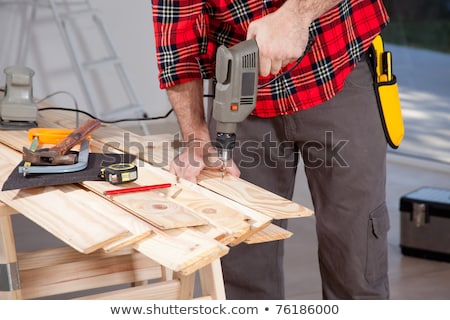 Foto stock: Tradesman Using A Power Tool