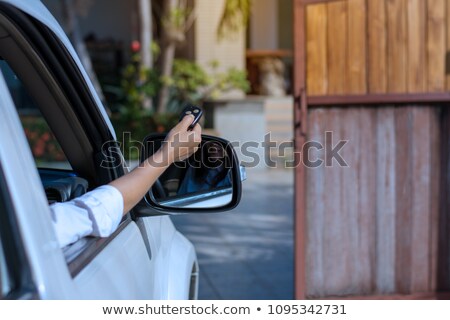 Foto stock: Beautiful Woman Using A Remote Controller