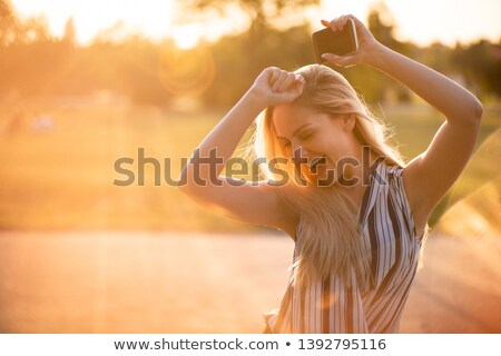 Zdjęcia stock: Joyous Woman Dancing With Arms Raised