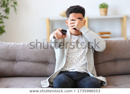 Foto stock: Stunned Men Watching A Horror Film