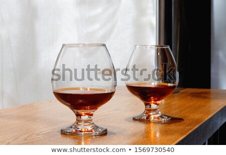 [[stock_photo]]: Two Goblets Of Brandy On Wooden Old Counter Top