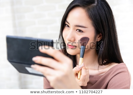 Stock photo: Beautiful Girl Applying Blush With Brush