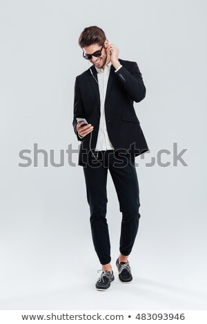 ストックフォト: Smiling Happy Young Businessman Litening Music With Earphones And Smartphone