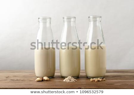 Almond Milk In A Glass Bottle And Almond Nuts On A Stand Stock foto © Frannyanne