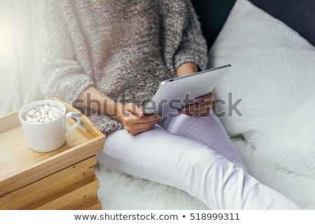 Foto stock: Close Up Of Woman With Cocoa Cup And Cookie In Bed