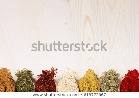 ストックフォト: Colorful Scattered Powder Seasoning In Paper Corners On White Wooden Board With Copy Space