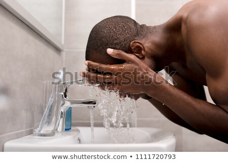 ストックフォト: Man Washing His Face