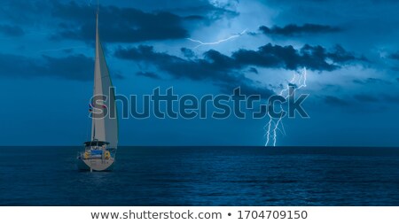 Foto d'archivio: Sailing Boat At Stormy Sea Horizon