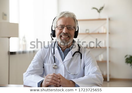 [[stock_photo]]: Doctors With Headsets Talk By Phone With Patients