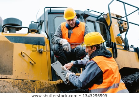 [[stock_photo]]: Worker With Heavy Excavation Machinery In Mining Operation